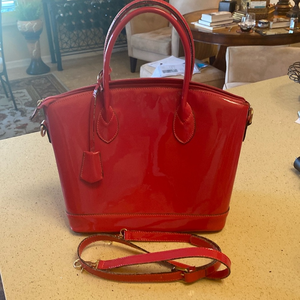 Handbag, detachable shoulder strap. 15” wide. 17” from bottom to top of handle.